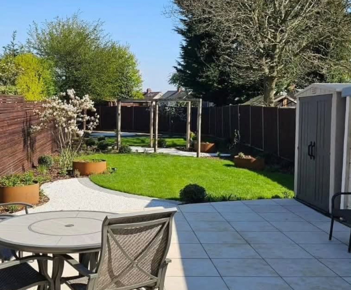 Porcelain patio and landscaped lawn with pergola