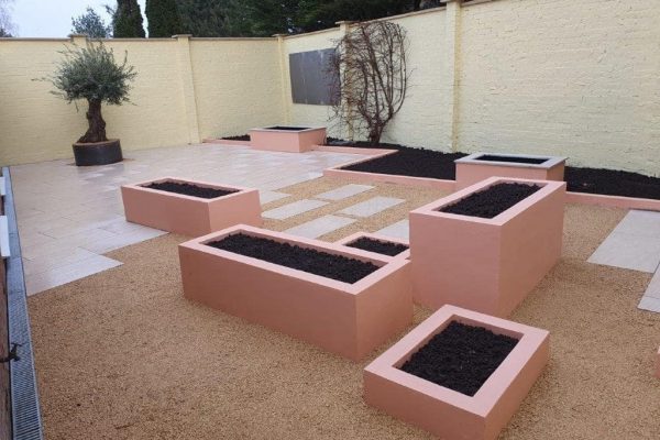 Rendered raised planters at different heights around porcelain paving