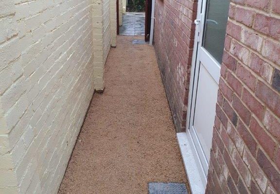 Gravel side path beside the house