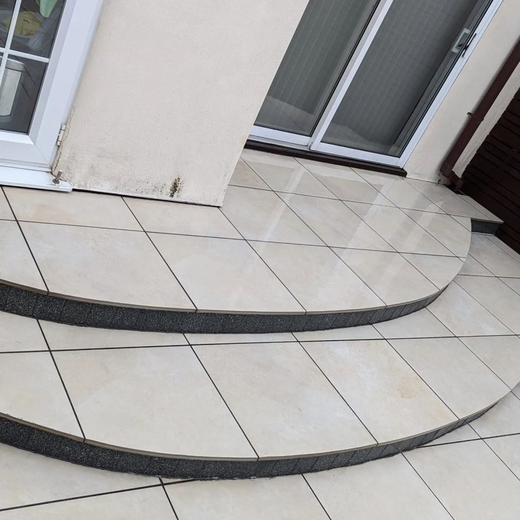 Curved porcelain steps outside the patio doors