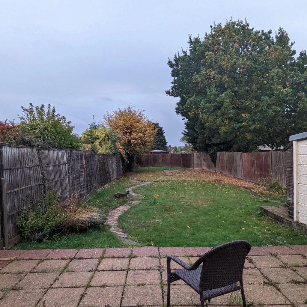 The garden before work began, with an old patio and lawn